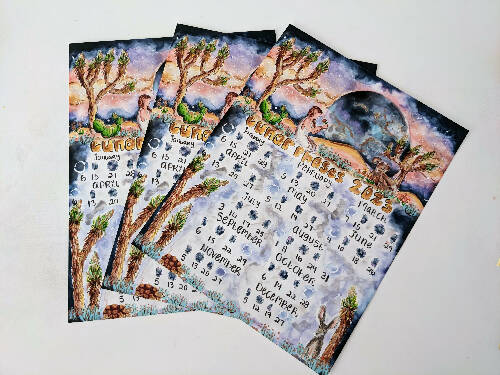 2023 Lunar Wall Calendar with desert themes like Joshua Trees, moon, mountains, cactuses, and desert animals sized 8.5x11"